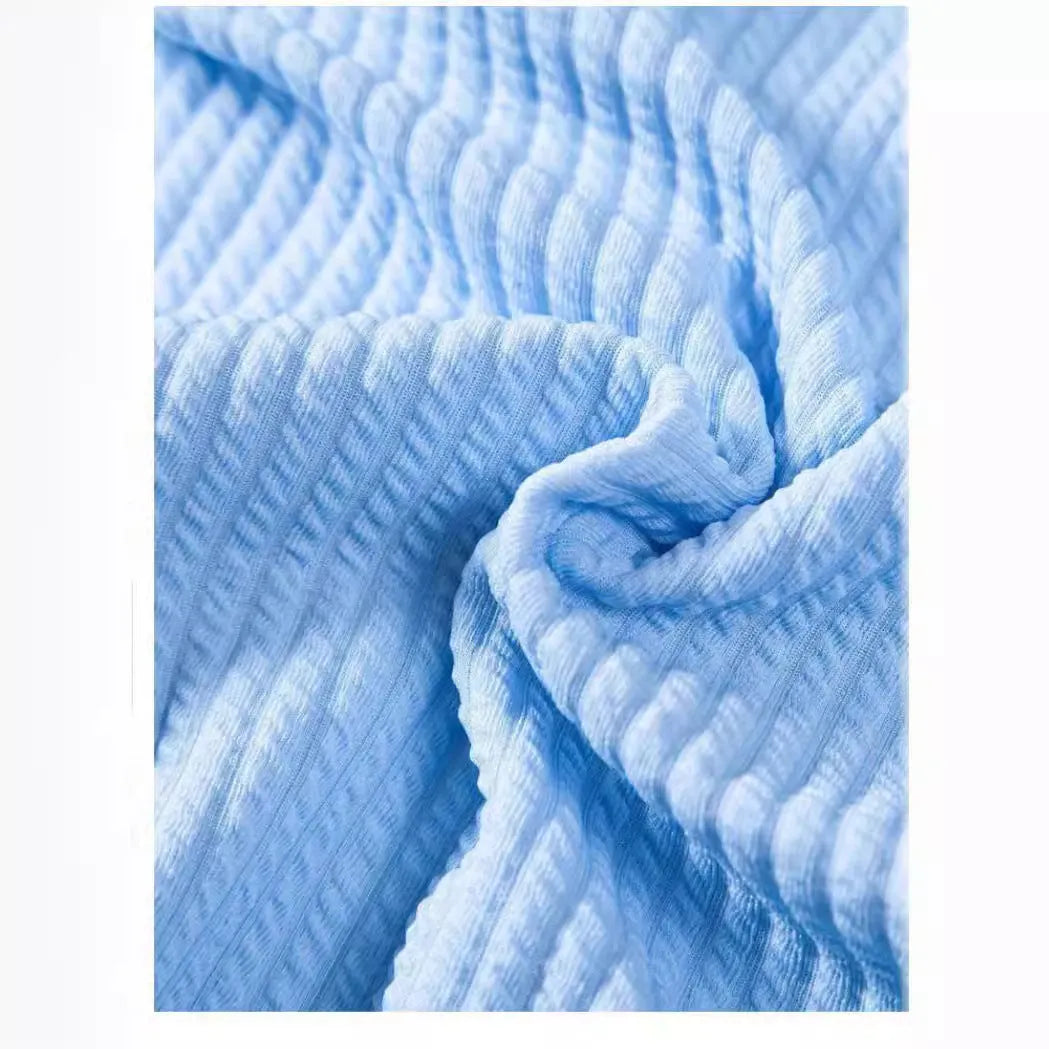 Men's loose-fitting short sleeve shirt in light blue polyester fabric on a hanger.