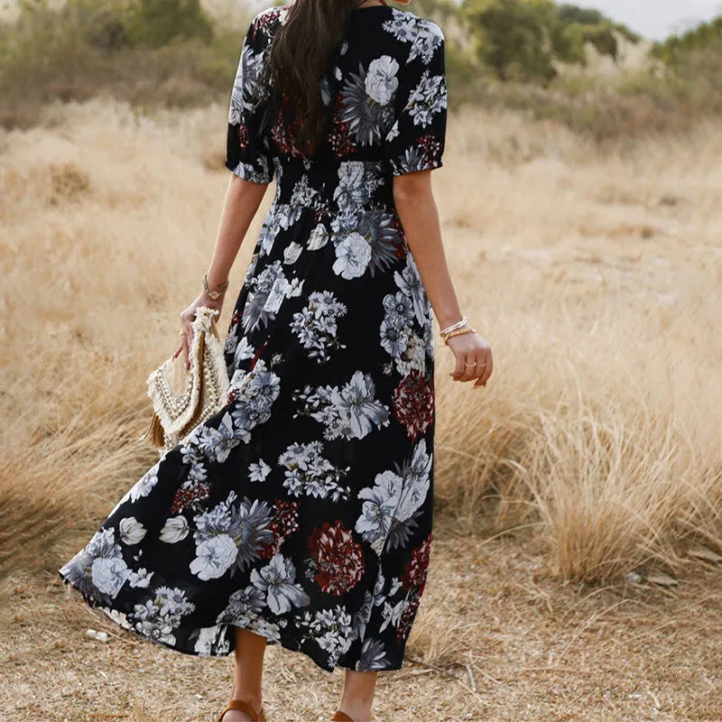 Yellow floral print dress on a hanger showing V-neck, short sleeves, elastic high waist, and full mid-length skirt.