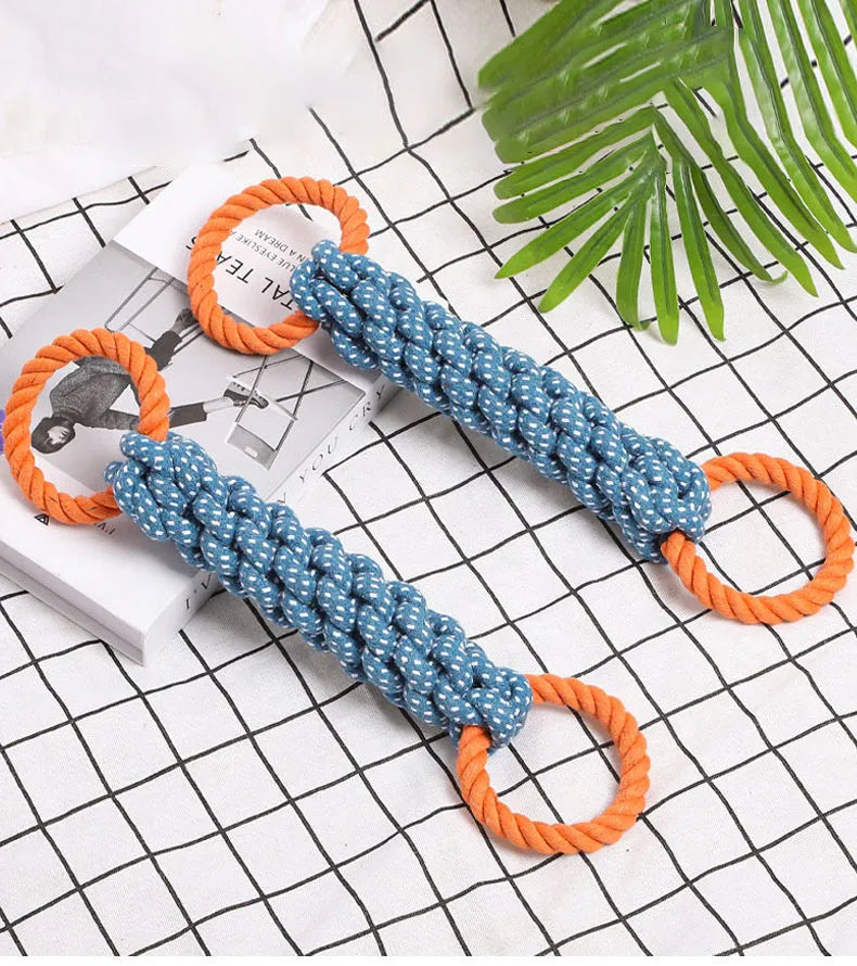 Blue braided cotton rope dog toy shaped like a bone with two rings, on a white background.