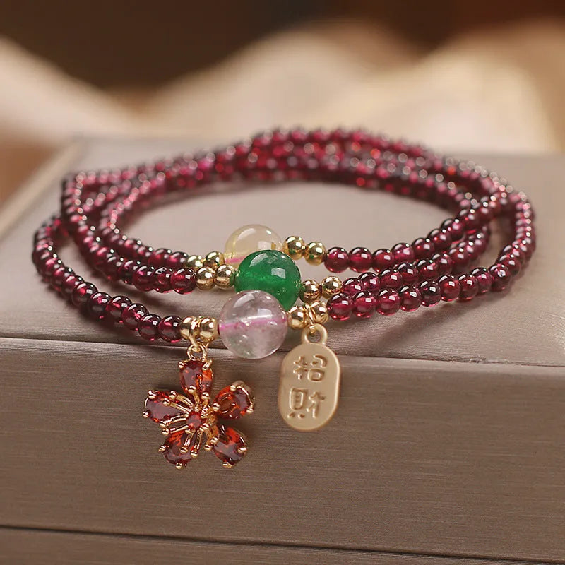 Women's crystal bracelet in pomegranate red cherry blossom colour with simple sequin detail on wrist