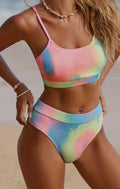 Women's blue and orange tie-dye pleated split bikini on a white background.