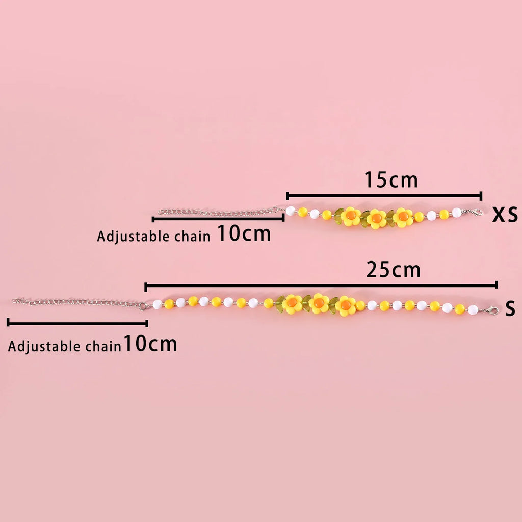 Colourful plastic bead pet necklace shown in peach, rainbow, and small flower patterns with an adjustable clasp.