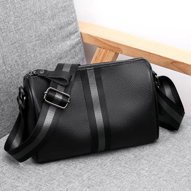 Black genuine leather crossbody bag with dimensions 24x16x13cm showing large capacity and polyester lining