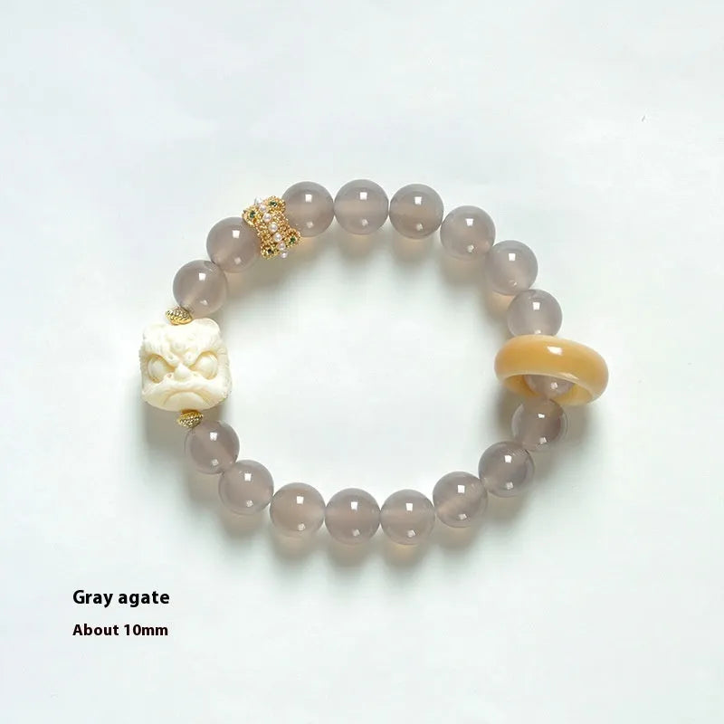 Hand-woven grey agate bracelet with ivory and mellite beads in a millet grain pattern