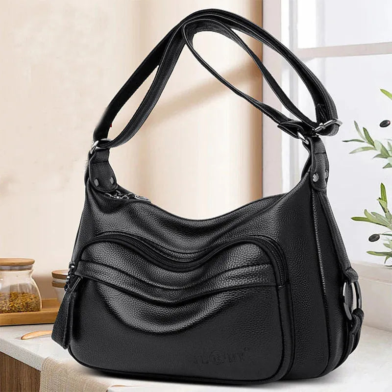 Large black women's crossbody shoulder bag with multiple internal compartments and zip closure