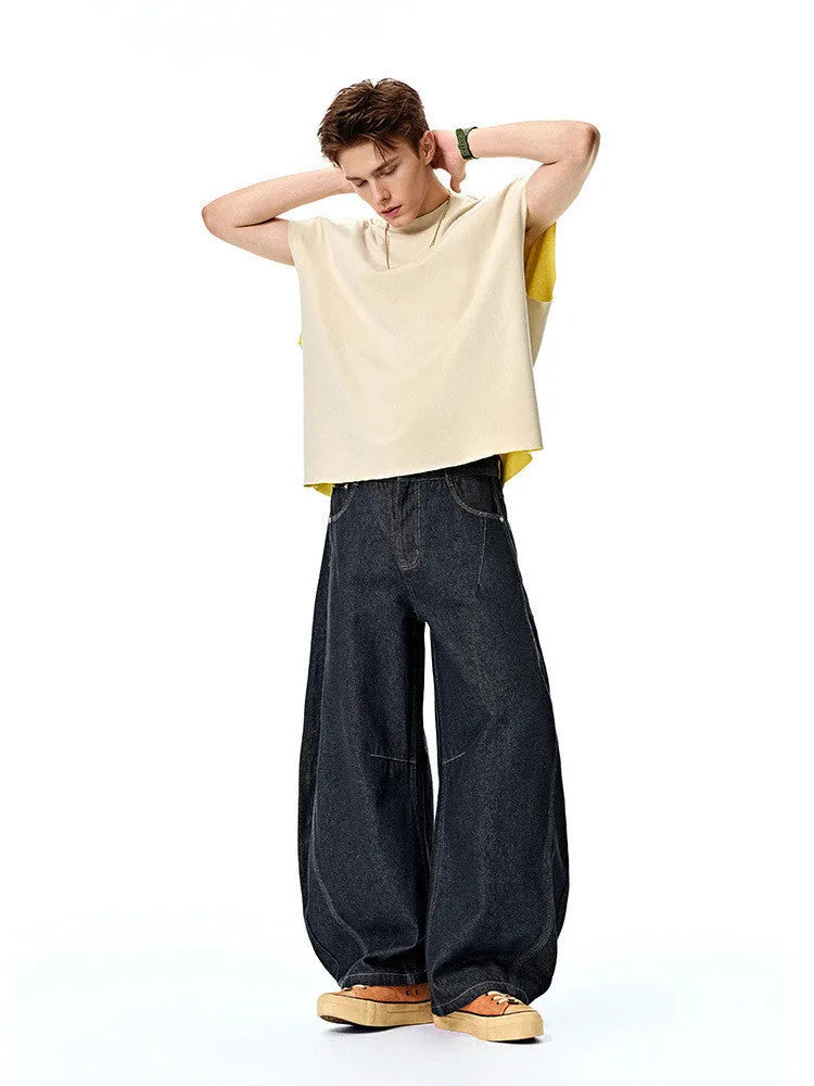 Men's wide leg denim trousers in original cow colour showing mid waist and relaxed fit.
