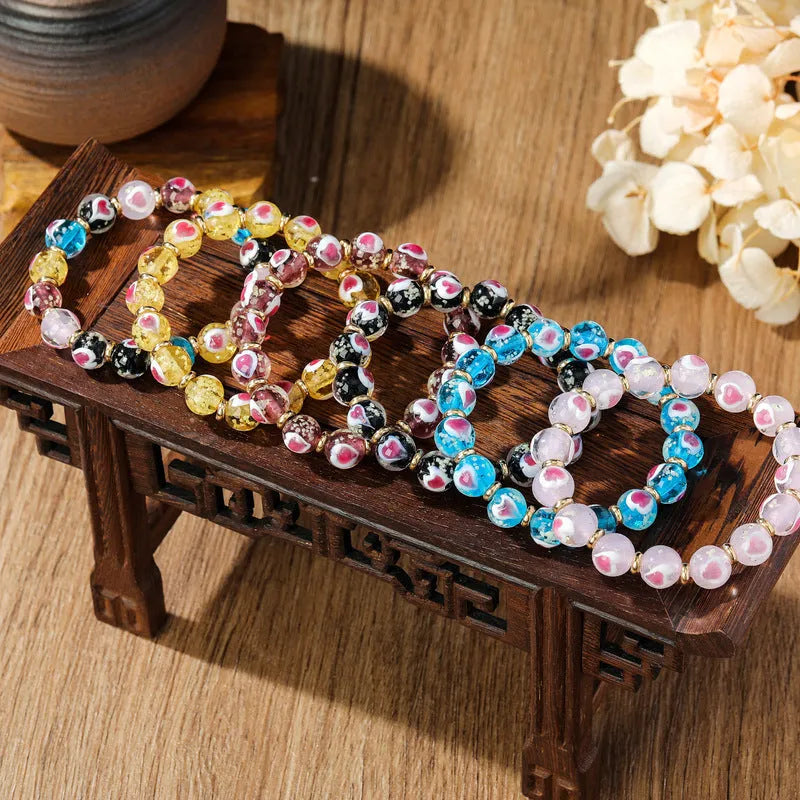Handmade glass bracelet with swallowing gold beast design on heart-shaped 10mm beads