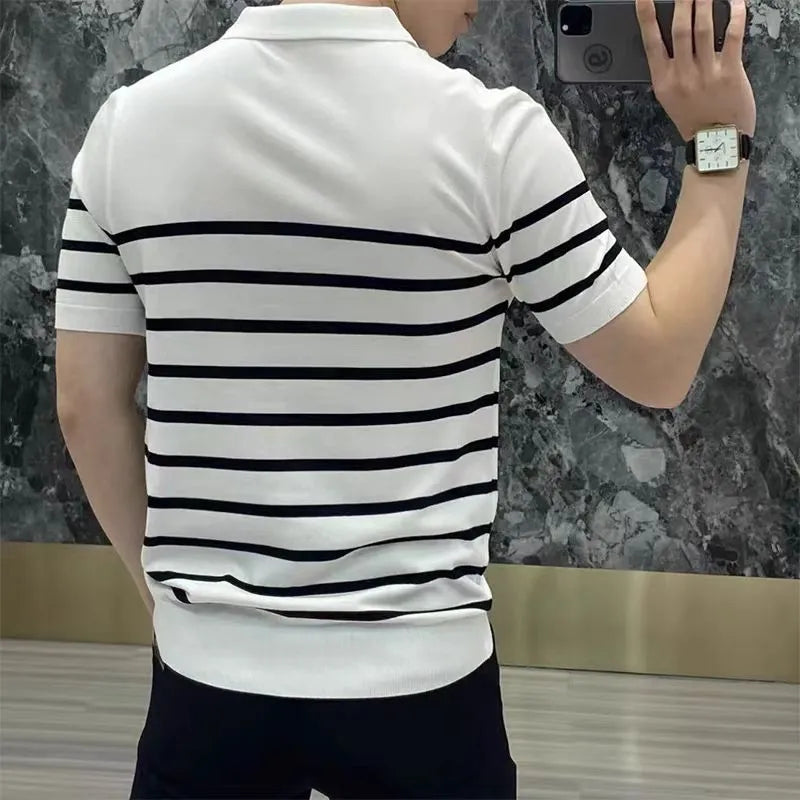 Black and white striped knitted pullover t-shirt with a lapel collar, laid flat.