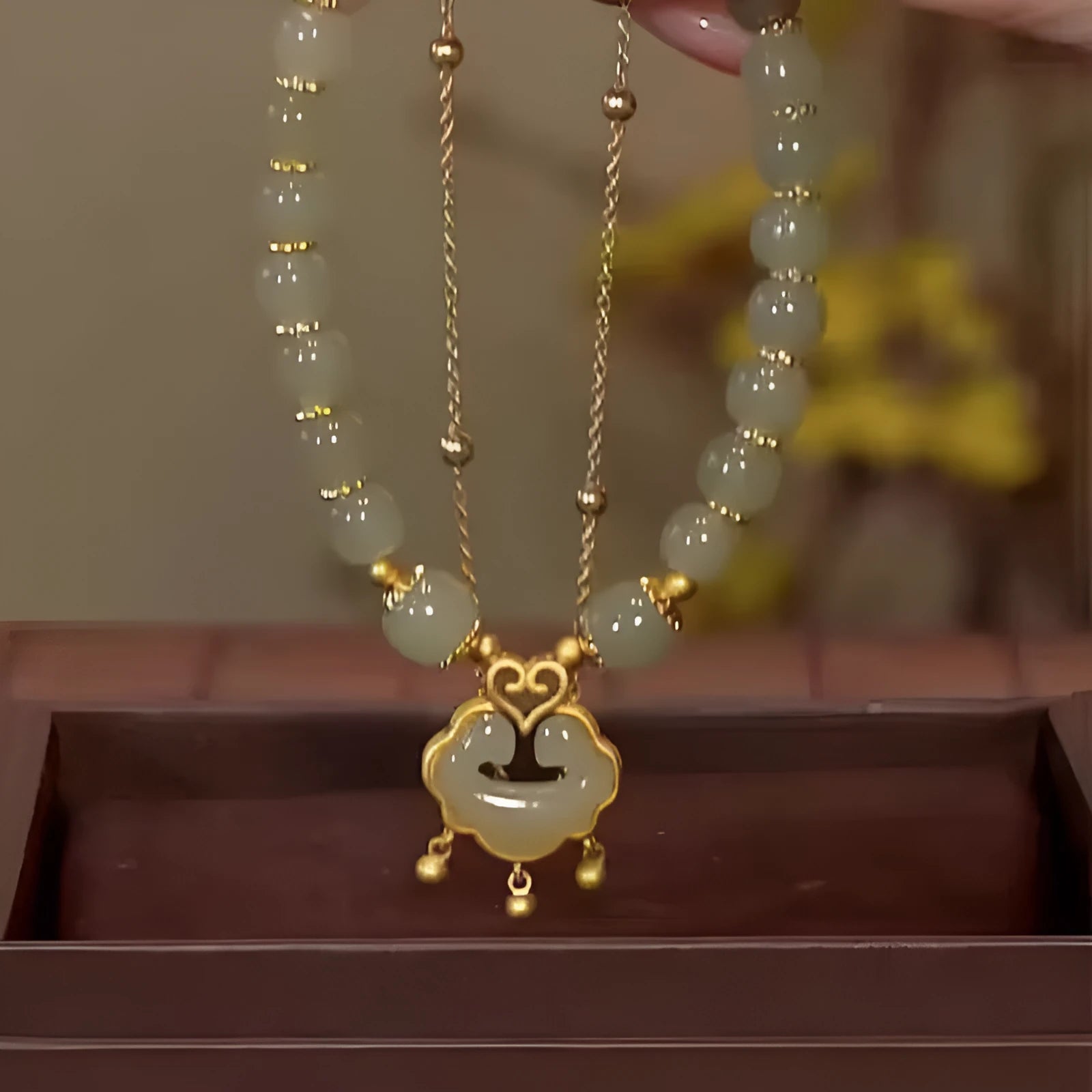 Women's green safety lock bell pendant bracelet with Xiangyun lock design on wrist