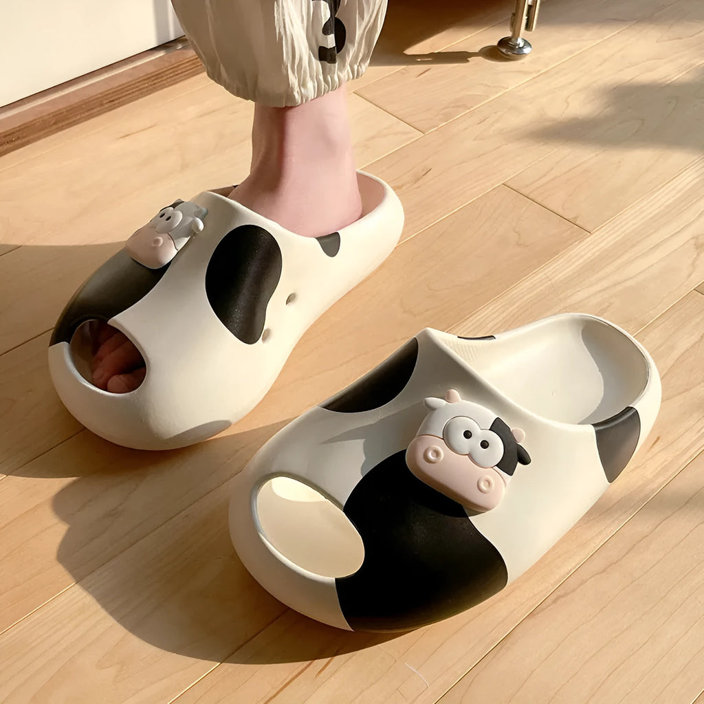 Thick-soled cartoon cow print EVA flip flops in black and white