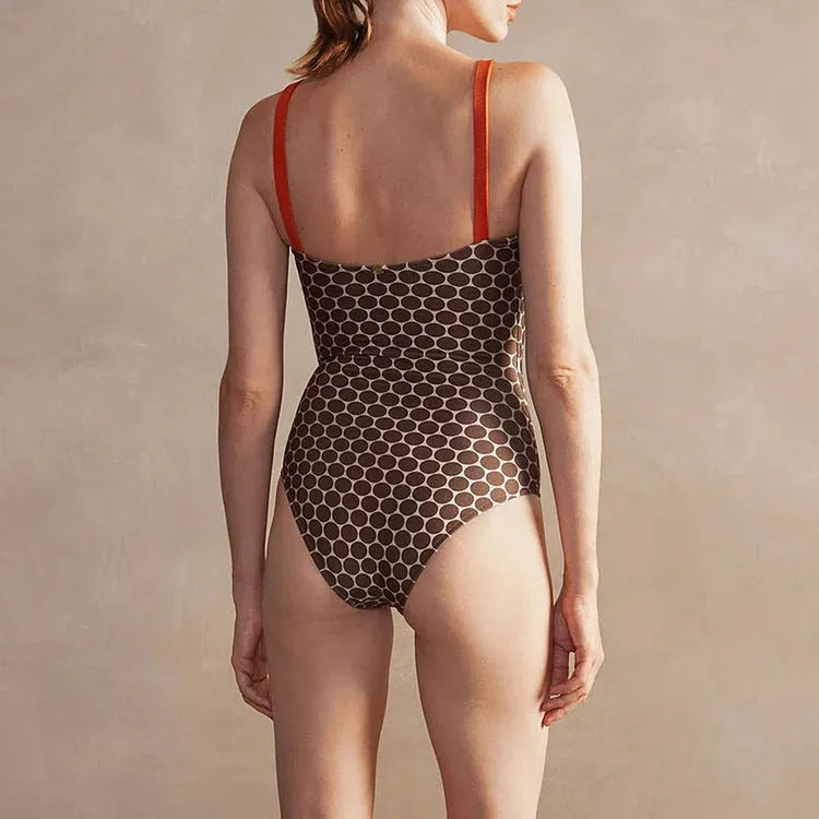 Women's printed dot one-piece swimsuit with a matching wrap skirt, shown on a mannequin.