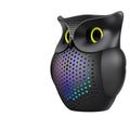 Black wireless Bluetooth speaker with a cartoon owl design on the front.