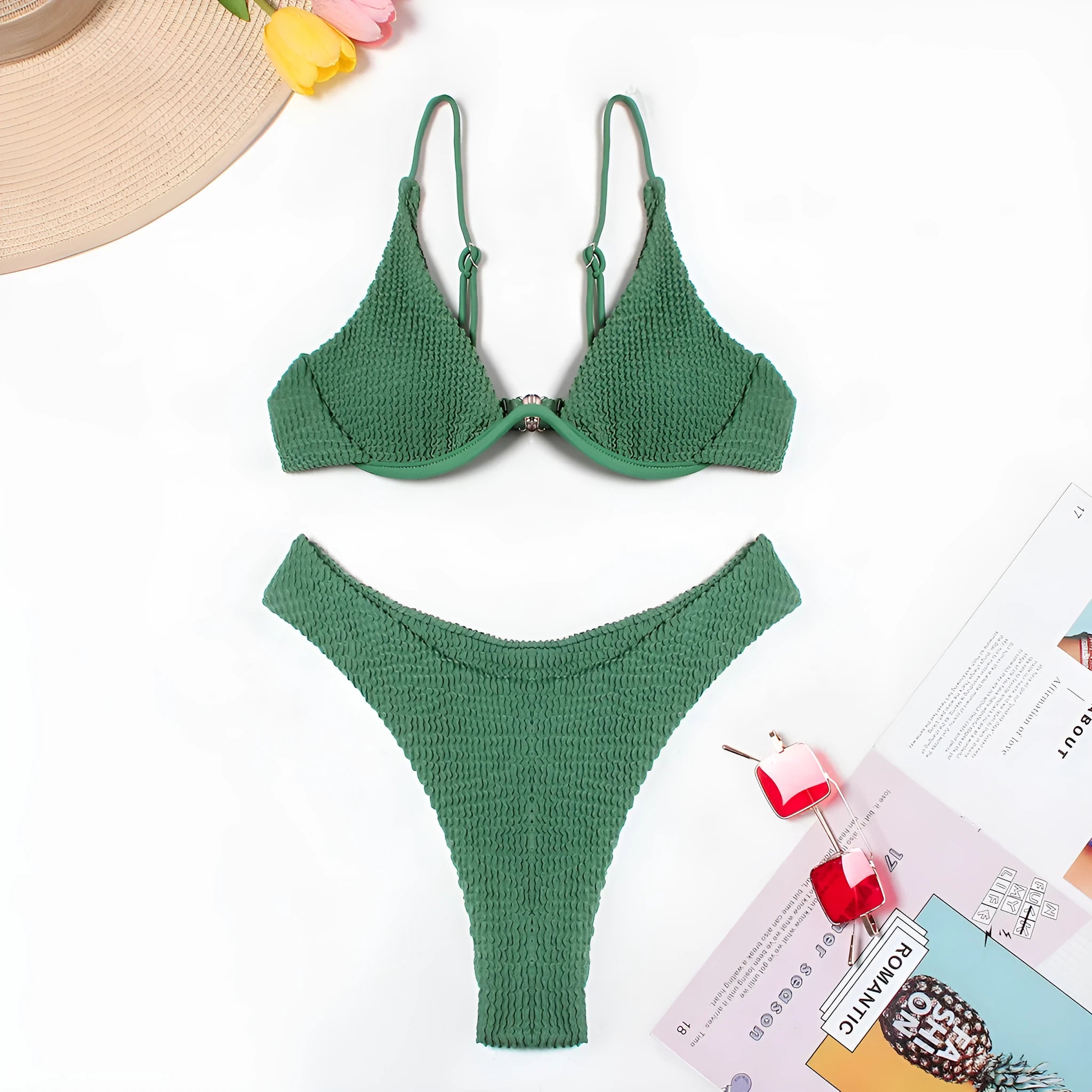 Women's solid green bikini suit with ruffle trim and split leg briefs on a mannequin.