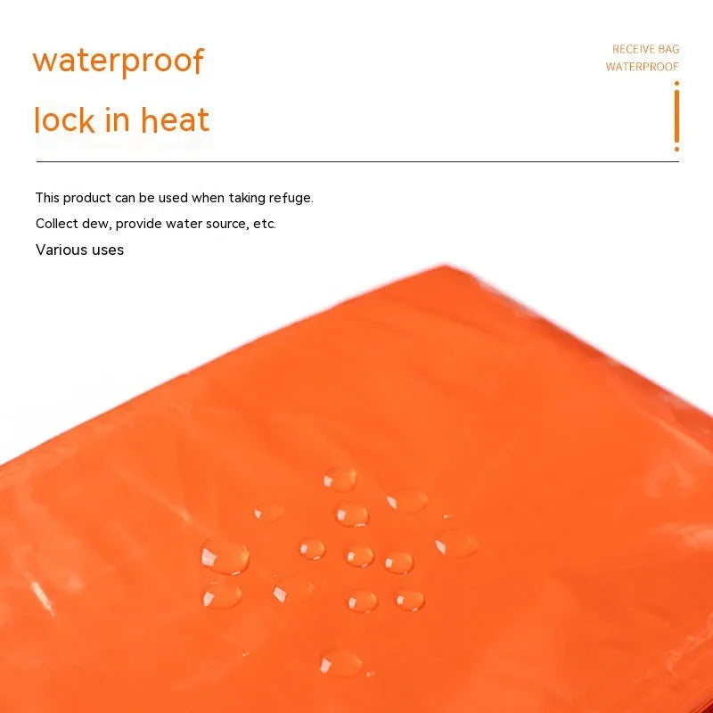 Orange portable disaster relief tent kit with sleeping bag and raincoat laid out