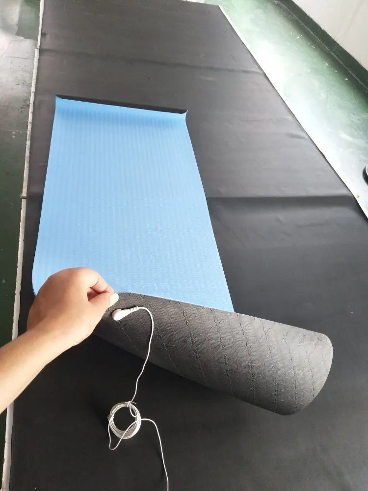 Blue conductive yoga mat with plant pattern and grounding wire, showing non-slip texture and 182cm length.