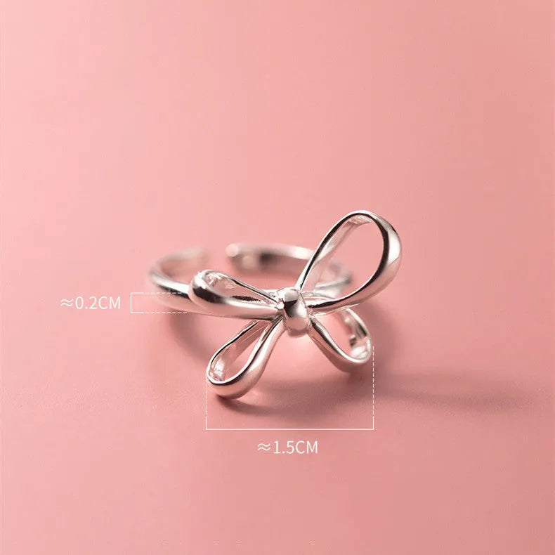 S925 silver bow ring with adjustable open band on hand, showing polished finish and Korean style design