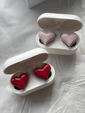 Heart-shaped wireless Bluetooth headphones in Chinese red colour with charging cable