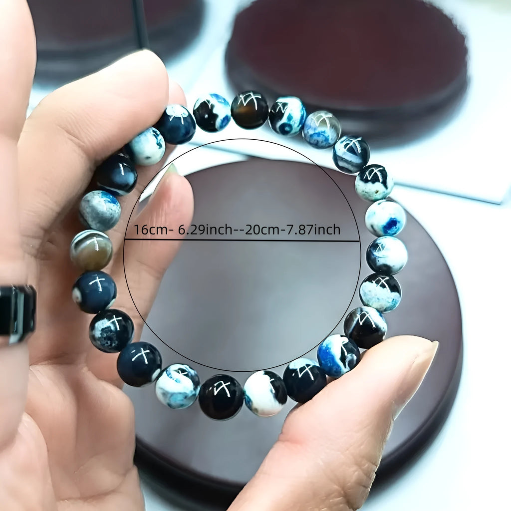 Close-up of a ladies bohemian bracelet with 8mm round glass beads in natural agate colours.