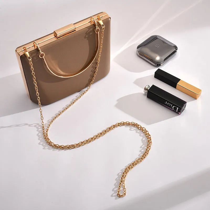 Solid colour PU leather crossbody bag in pillow shape with double-ring detail, 18.5x13.5x7cm, in black.