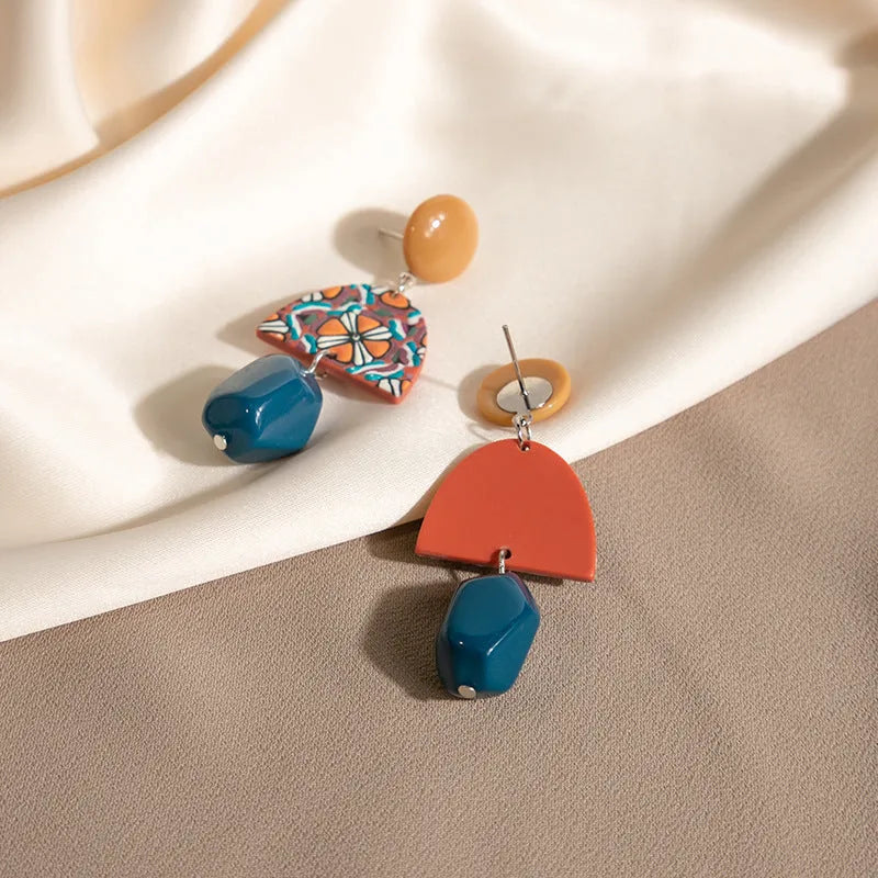 Retro yellow blue contrast acrylic earrings with irregular geometric shapes on white background.