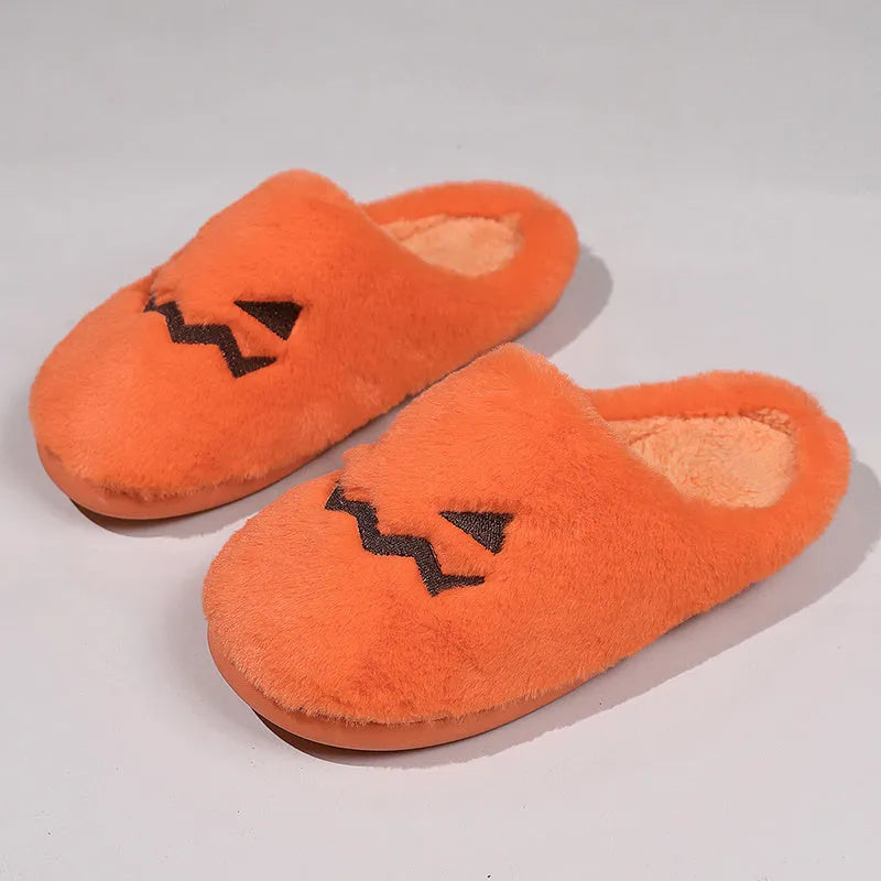 Orange Halloween pumpkin-themed plush indoor slippers with a non-slip PVC sole.