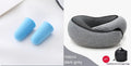 Navy blue U-shaped travel neck pillow rolled up next to its carry bag