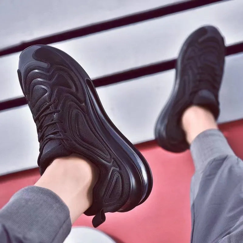 Men's black casual sneakers with lace-up front and thick sole.