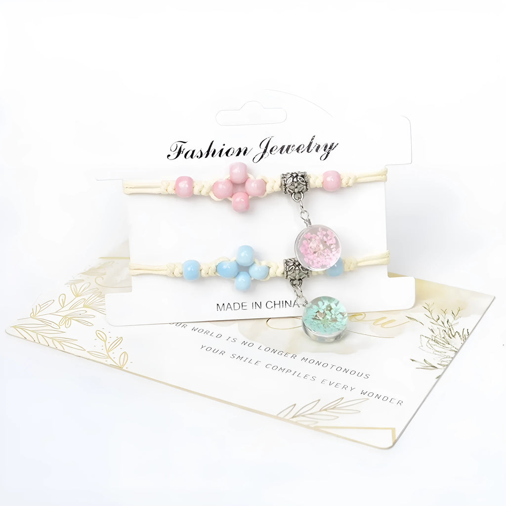 Close-up of a hand-woven glass bracelet with large 1.4cm beads containing real dried flowers and lace floral detailing.