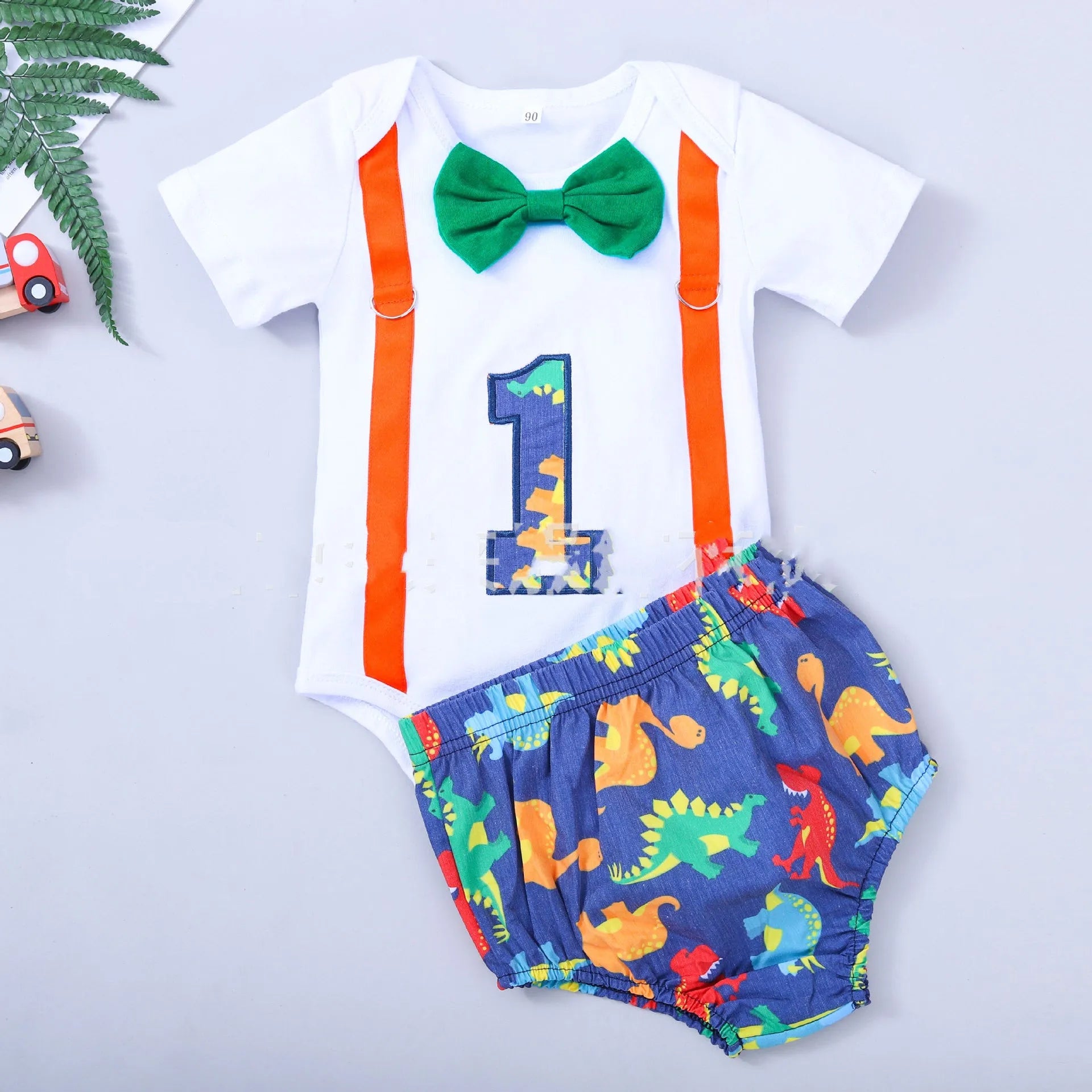 Cotton baby romper with dinosaur print and bows in blue