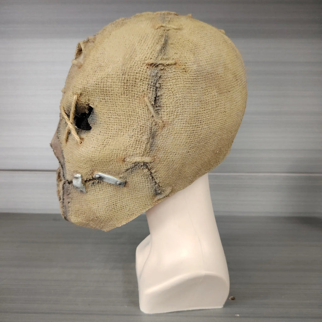 Latex Halloween mask featuring a detailed scar skull design, shown as a full head cover.