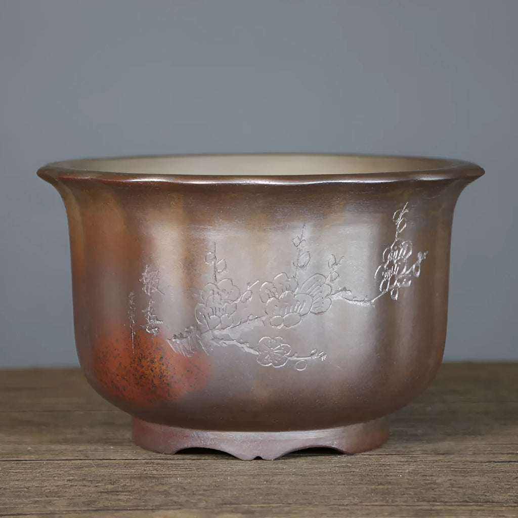 Antique carved wood burning finish on a purple sand ceramic bonsai flowerpot.