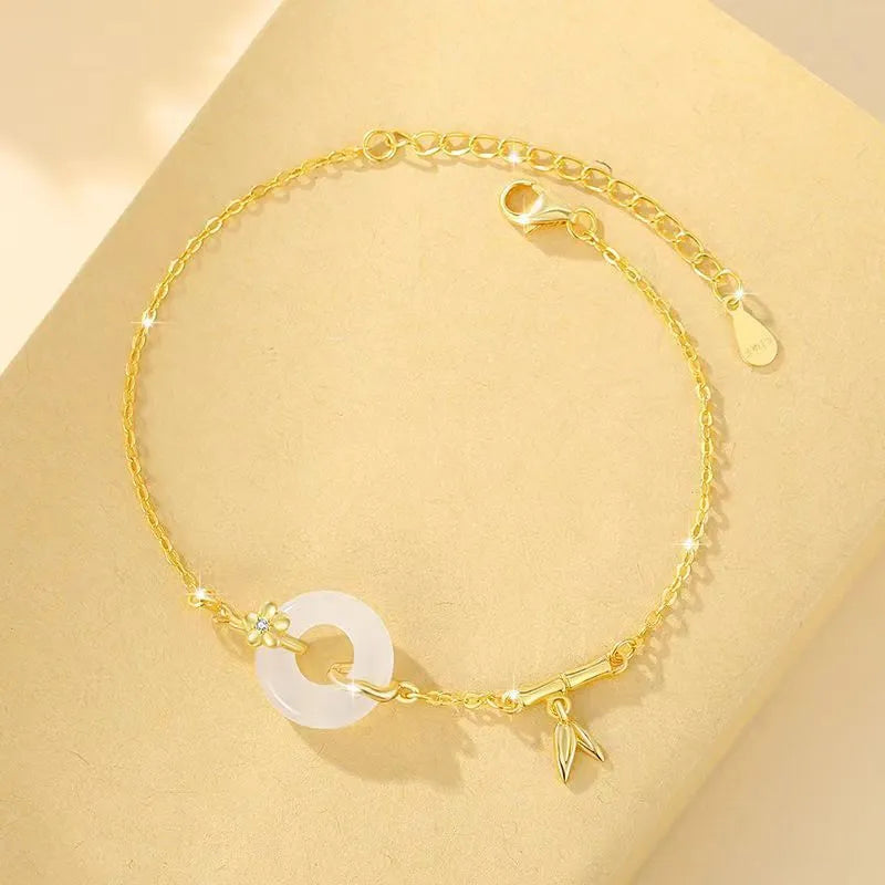 Silver bracelet with white chalcedony stone and starry sky patterned gold peace buckle.