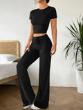 Black polyester two‑piece co‑ordination set with high‑waist trousers and a short‑sleeve t‑shirt.