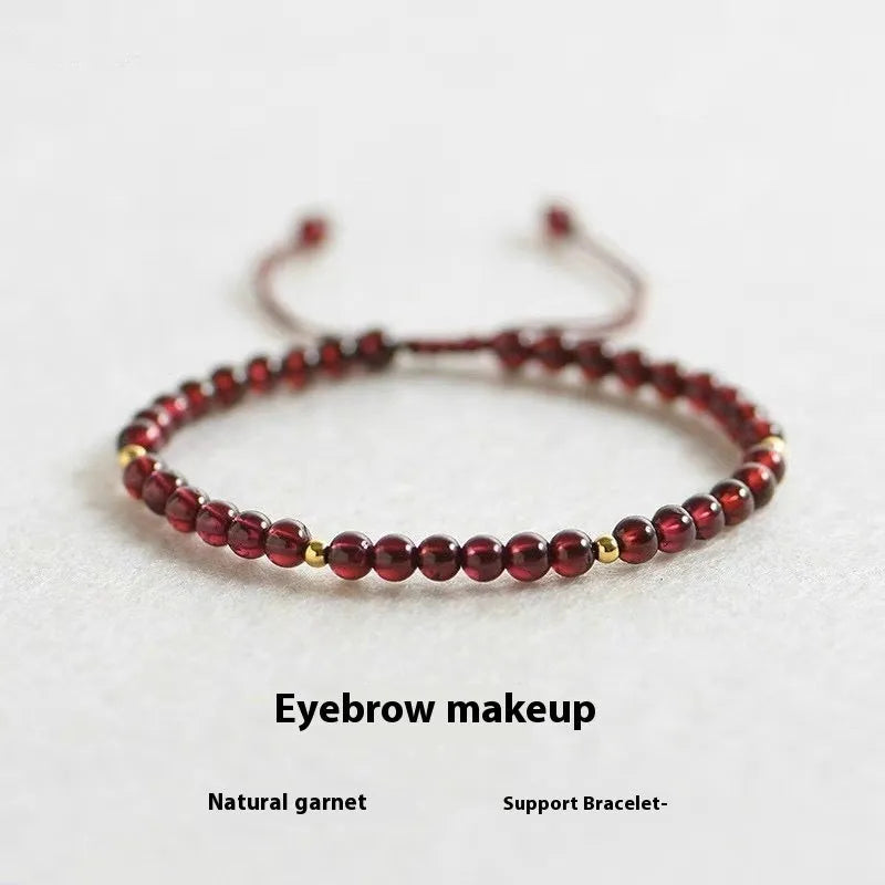 Hand-woven garnet red rope bracelet made from flexible wire, showing national tide style.