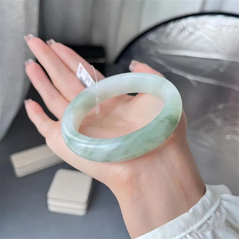 Tian Shan Cui jade bracelet with ice-like floral pattern and adjustable 52mm-64mm sizing.
