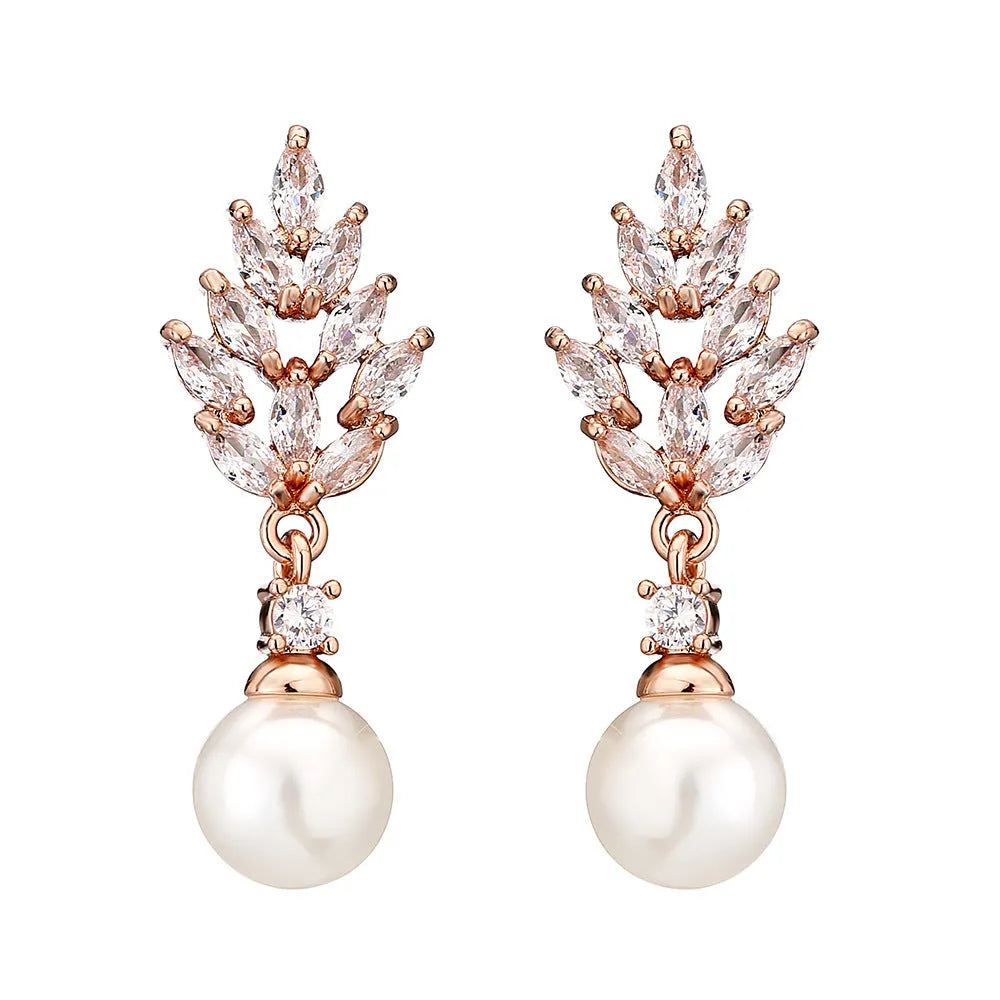 Geometric flower-shaped earrings with micro inlaid zircon and pearl details on a gold-toned metal base.