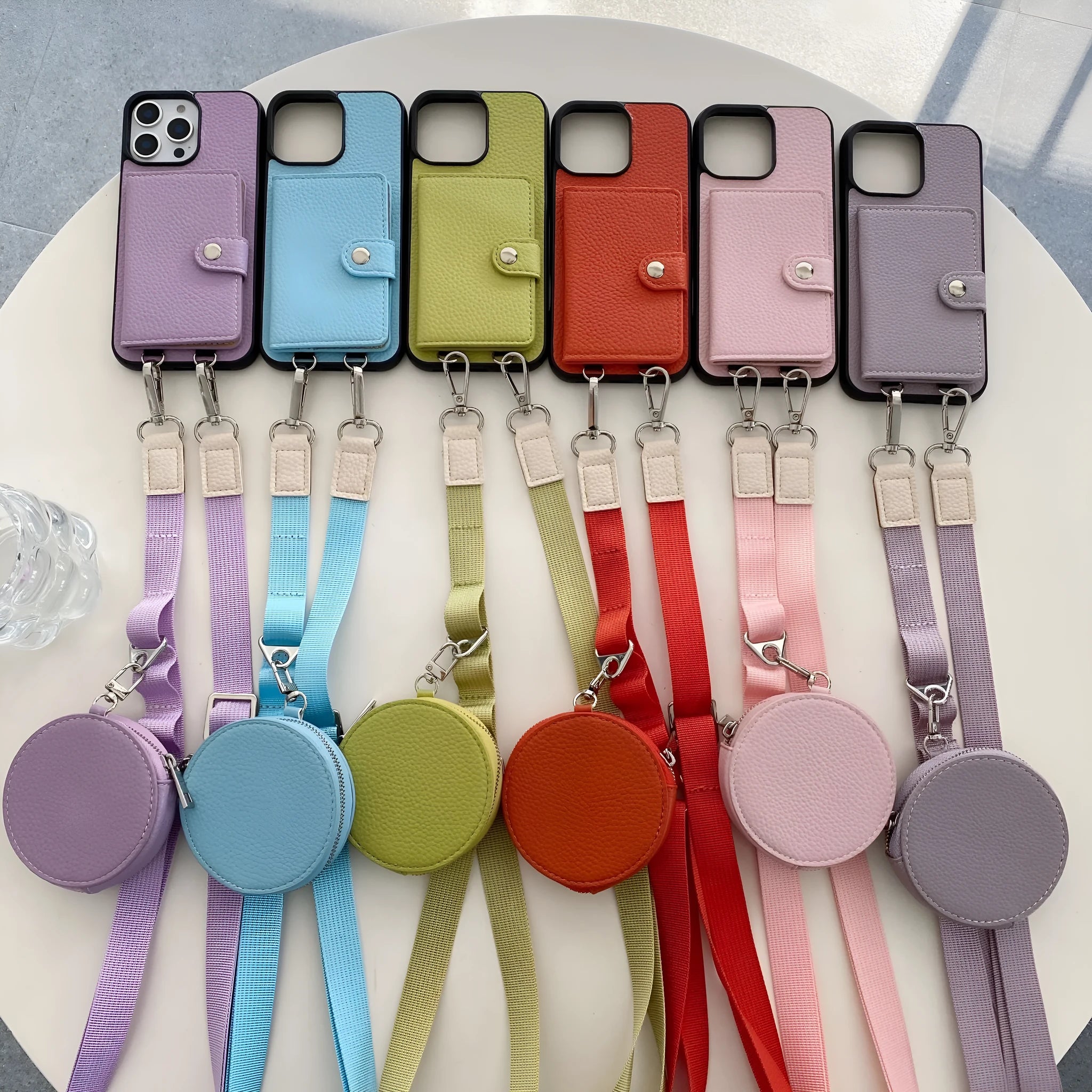 Black card holder lanyard phone case for iPhone showing integrated card slots on back and adjustable neck strap.