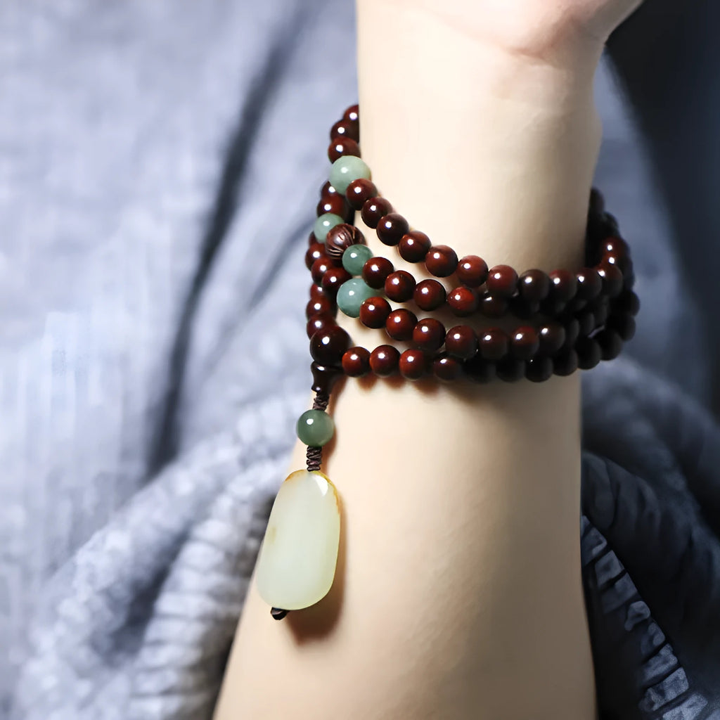 Rosewood bead bracelet with a carved Pterocarpus Santalinus and Hotian Jade stone pendant.