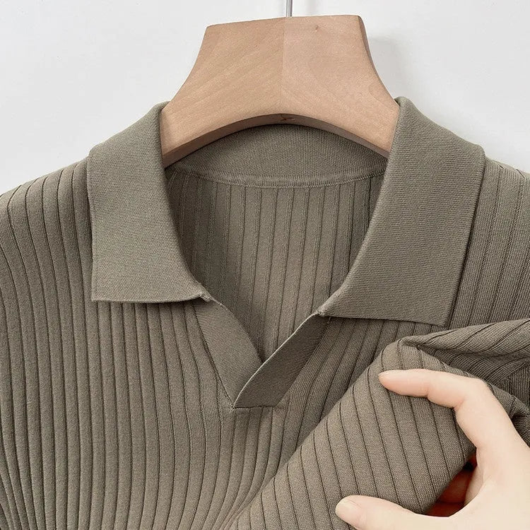 Man wearing a striped mulberry silk T-shirt with a lapel collar in a neutral colour.