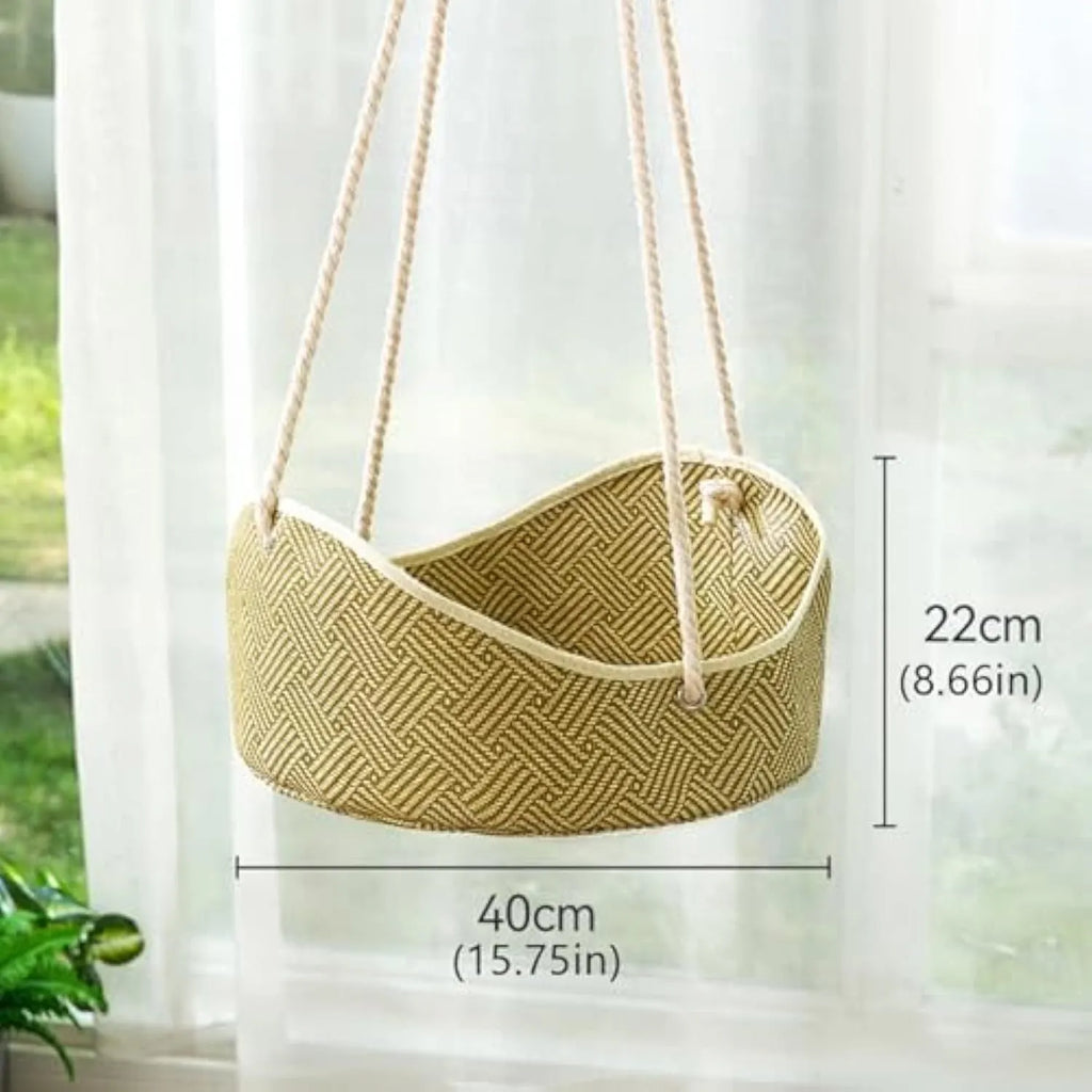 Green rattan cat hammock with cotton ropes and metal hooks, shown hanging.