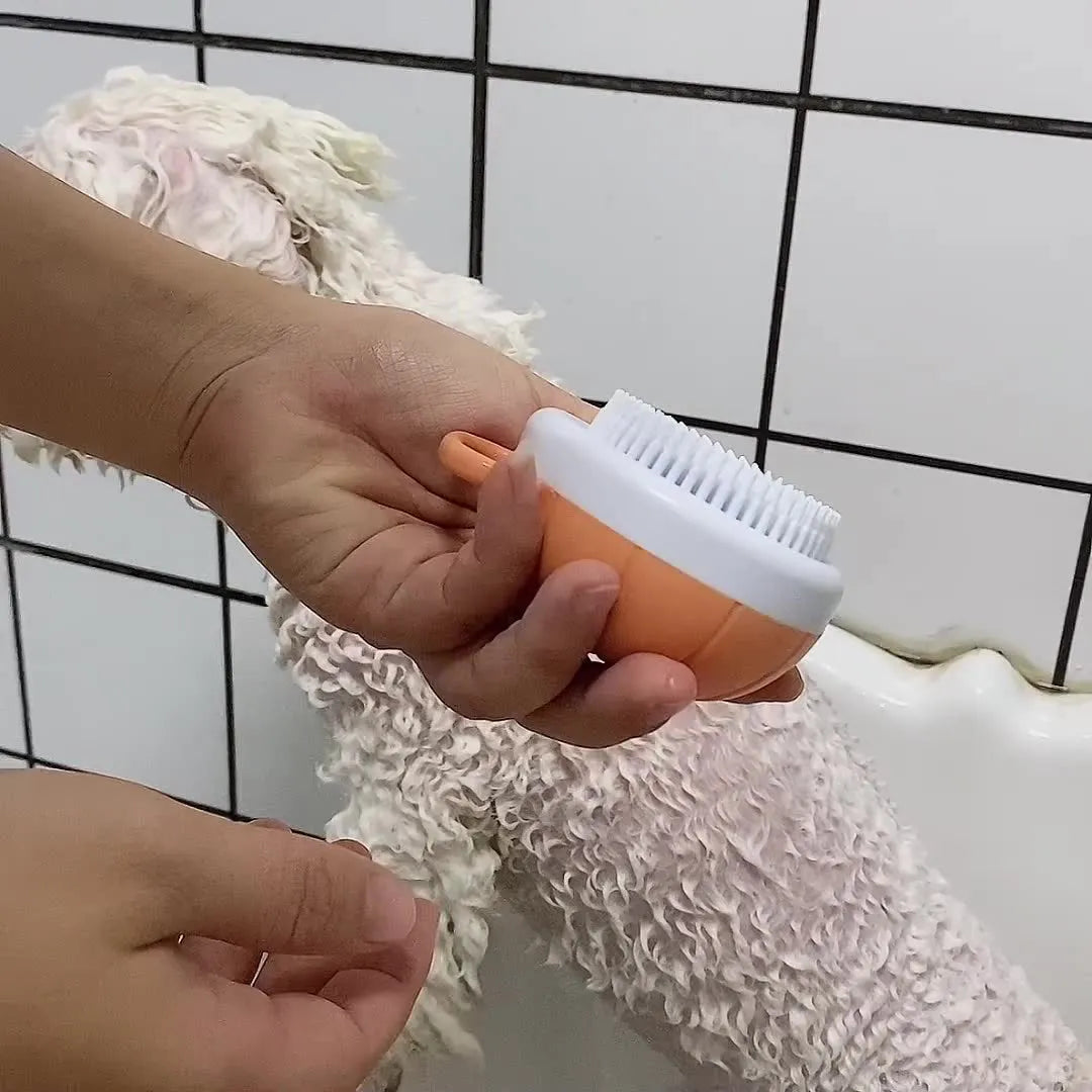 Orange silicone dog bath brush with shampoo dispenser and soft TPR bristles for pet grooming