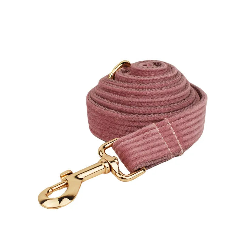 Red corduroy dog collar and leash set with matching vest, bow tie, and poo bag