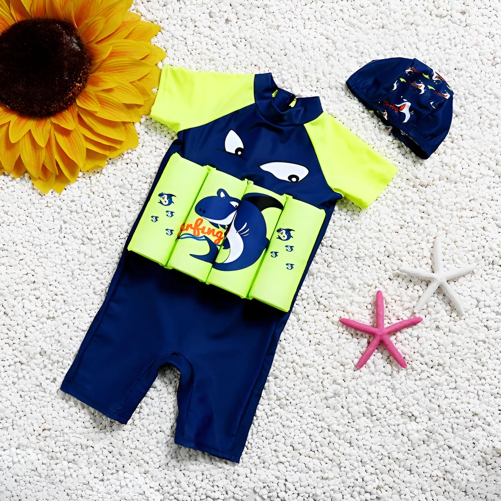 Child wearing a cartoon print buoyancy swimsuit in a swimming pool.