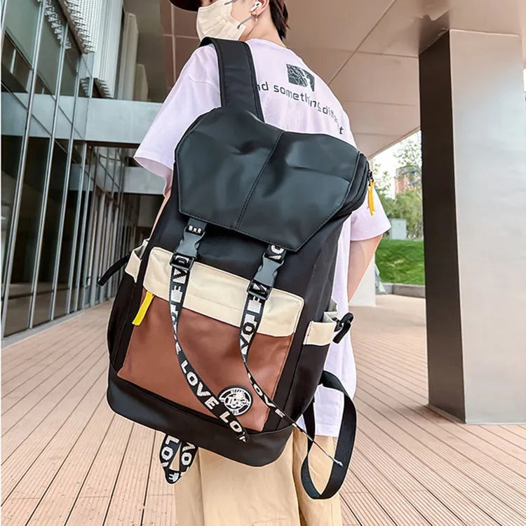 Oxford cloth backpack in black, green, or red with multiple carry handles and straps.