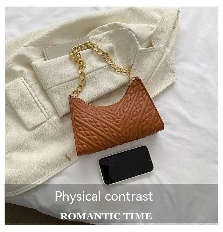 Brown vertical PU leather shoulder bag with a silver pleated chain strap and a soft handle.