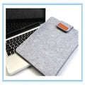 Dark gray felt laptop bag open showing plush lining and tablet compartment