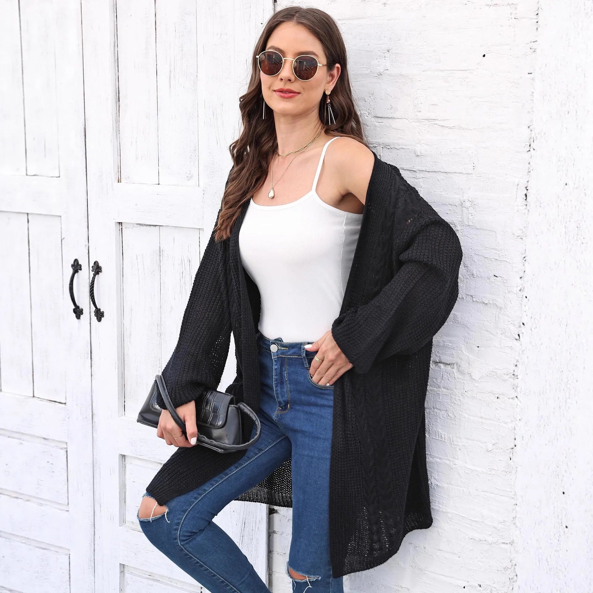 Brown loose-fitting acrylic sweater coat for women on a hanger.