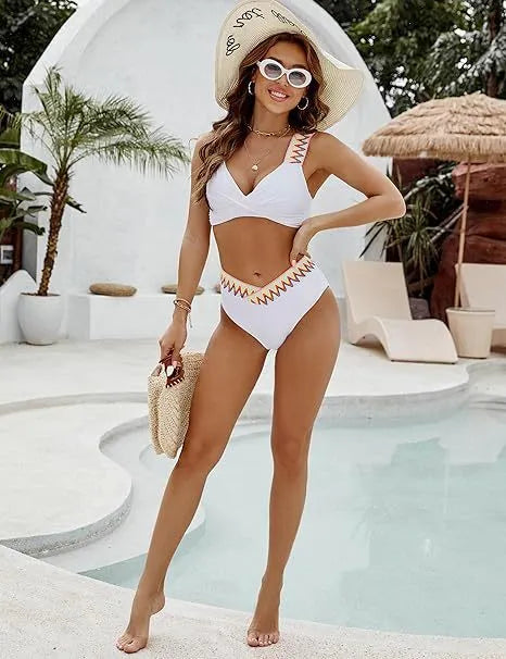 Black and white women's lace-up front bikini with high-waisted swim shorts.