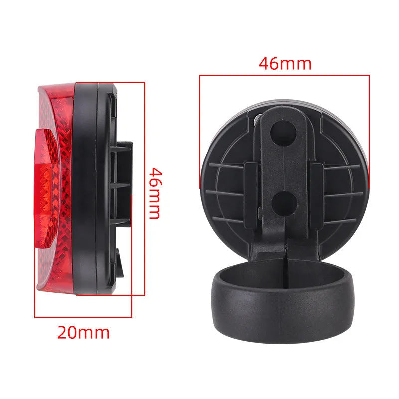 Red plastic anti-theft bicycle taillight bracket with integrated reflector mounted on a seat post.