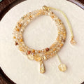 Caramel coloured citrine crystal women's bracelet with multi-layer design and Saturn decorative elements